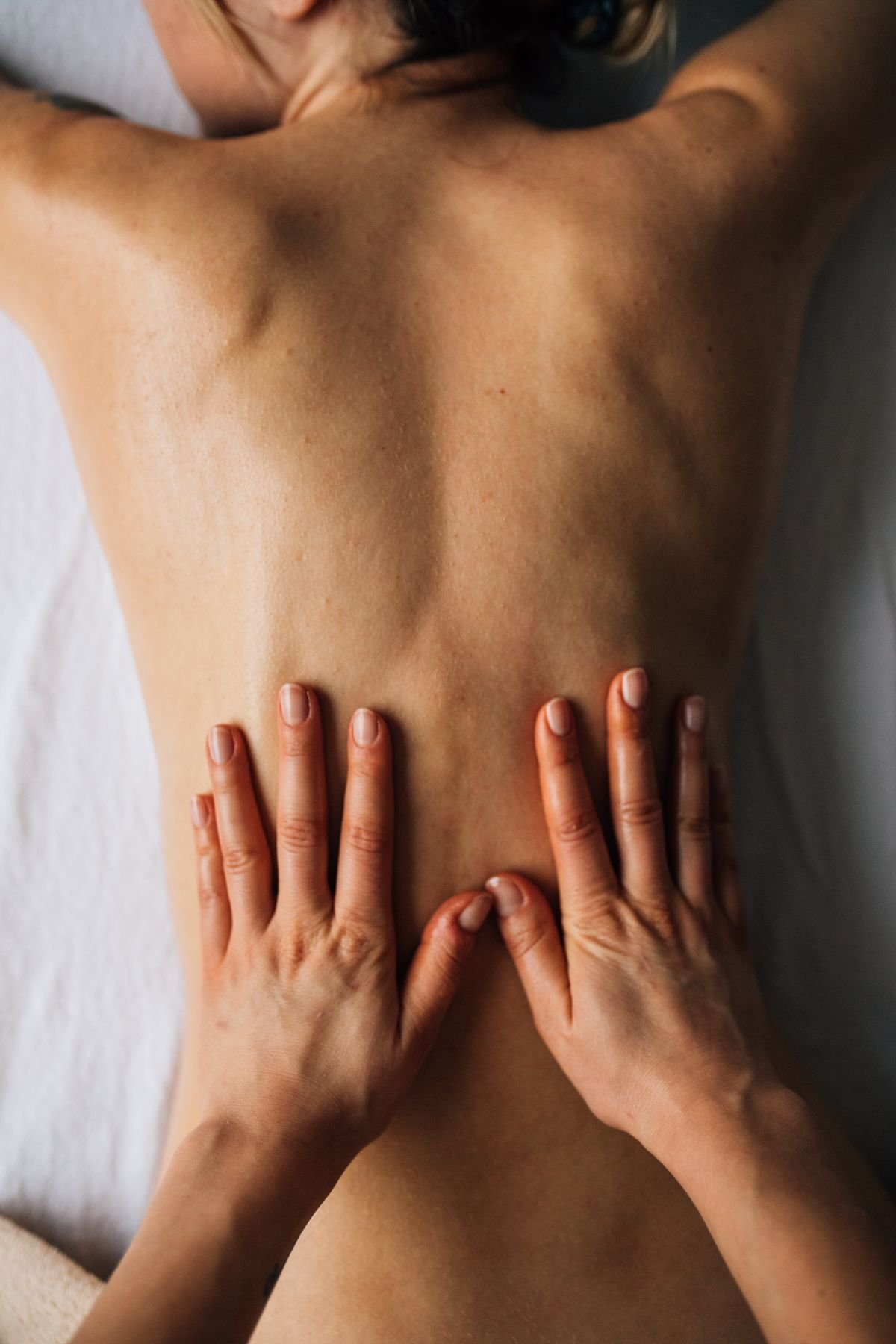 Close-up of hands performing a back massage at Ganga Spa