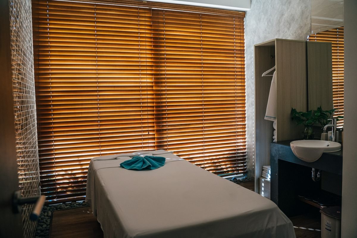 A tranquil, softly lit treatment room with natural light at Ganga Spa